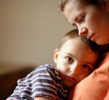 A mother sits with her son in a meeting with a Lake Forest divorce attorney.