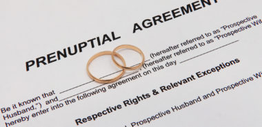Prenuptial agreement document with weddings rings representing how our Chicago divorce attorney can assist you with creating a prenup agreement