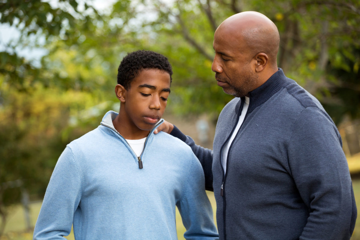 Father talking with his son representing how our Chicago divorce lawyers can assist you on the best ways to discuss divorce with your children.