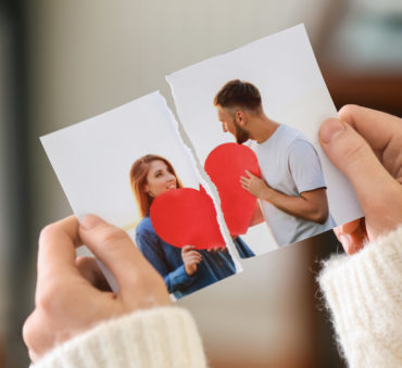 Woman tearing up a photo of couple, if considering divorce meet with a Chicago Loop separation attorney.