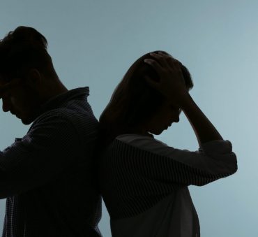Silhouette of a couple standing back to back upset, when you have marriage problems that cannot be resolved meet with Divorce Settlement Lawyer Chicago.