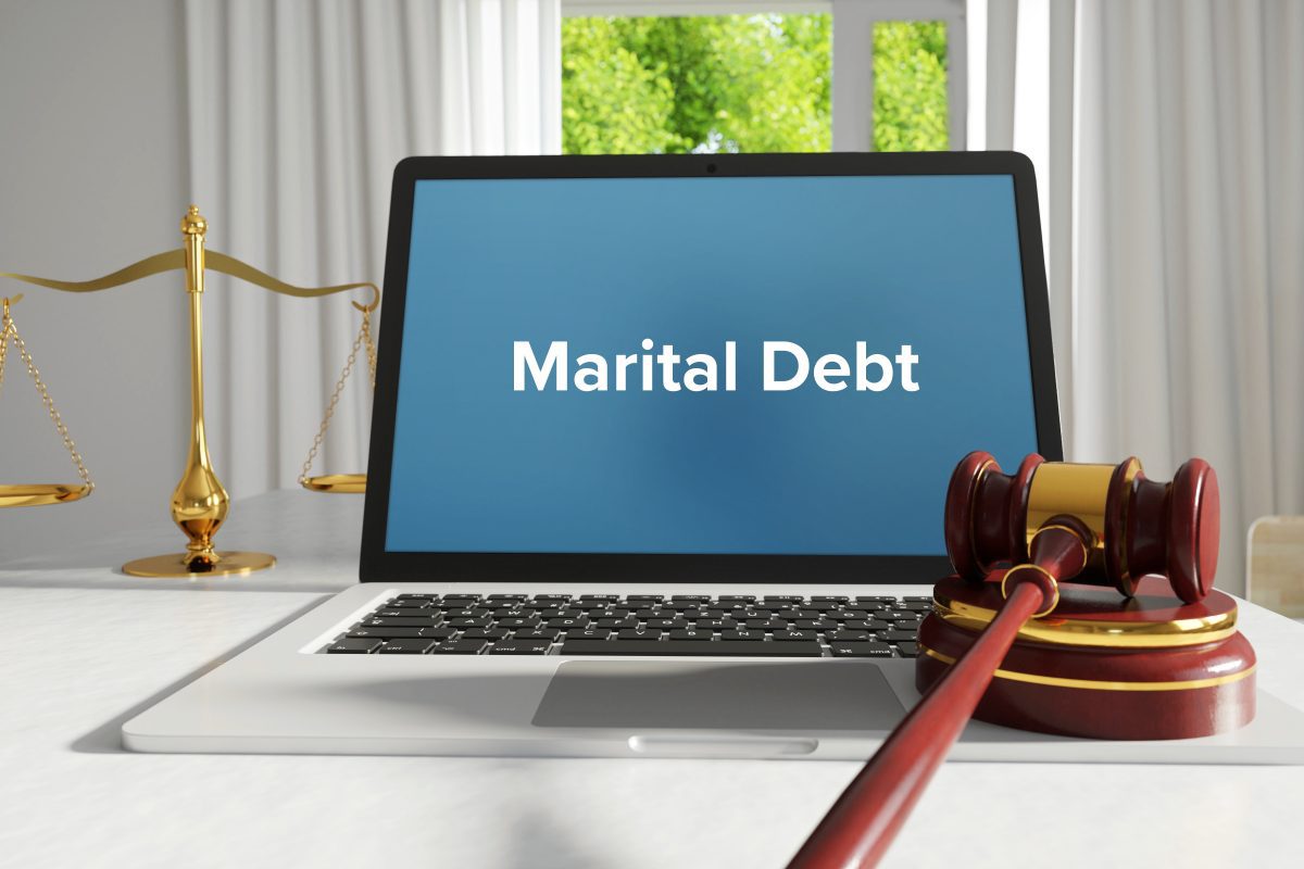 Marital debt on a laptop with gavel, contact Chicago Property Division Attorney when needing guidance on marital assets.
