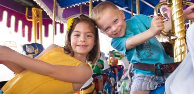 boy and girl on carousel at fair in summer when determining parenting plan with Child Custody Attorneys in Downers Grove.