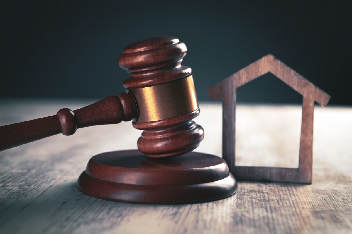 Judge gavel and houses on a wooden background. The concept of property division with the help of a Chicago Divorce Attorney.